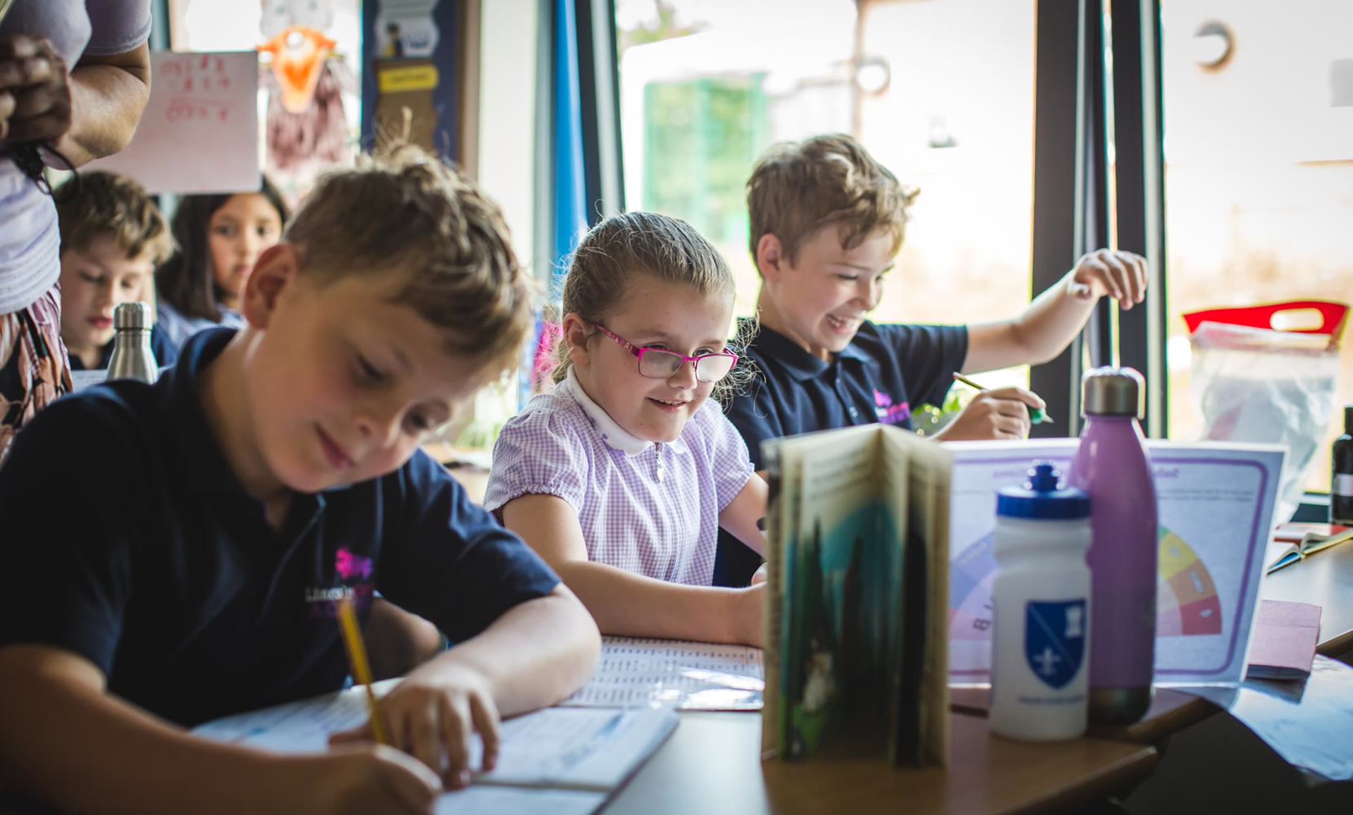 Junior School students working together at their classroom desk