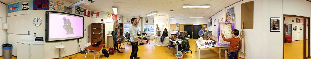 Panoramic view of a Northwood Junior classroom with a teacher presenting