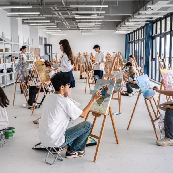 Senior School students painting at easels in the art studio