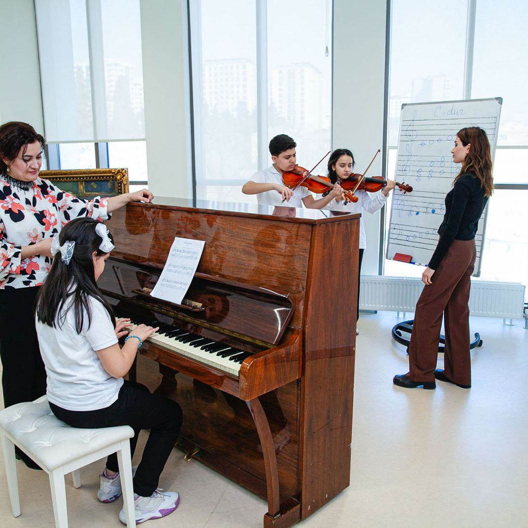 Senior School students rehearsing strings and piano together